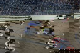 Cars racing around track