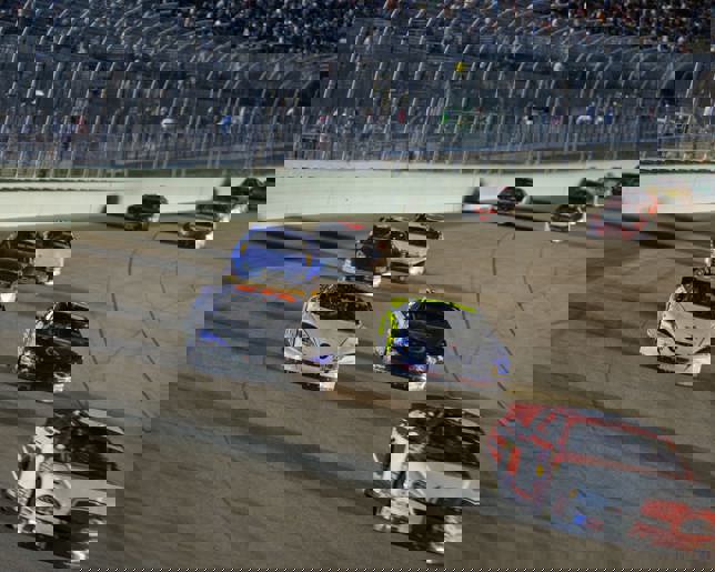 Cars racing around track