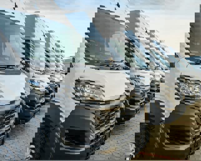 Commercial delivery vans parking in a row, transporting and shipping service company