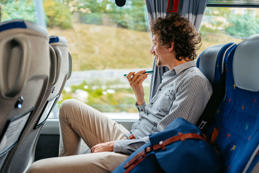 Man sending voice message in bus