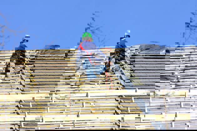 Roofer is working on the roof 