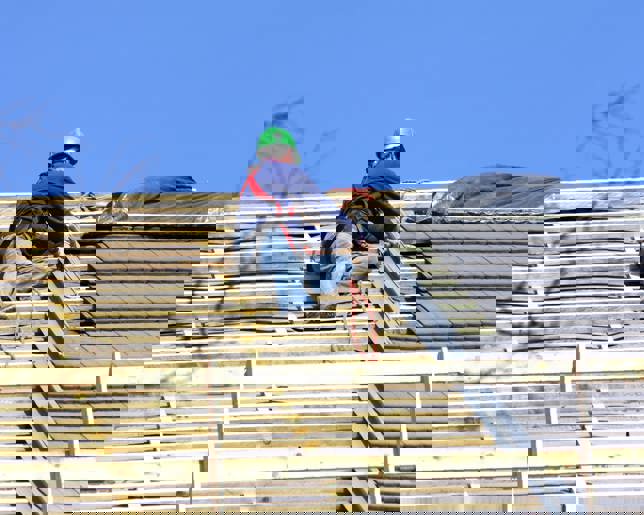 Roofer is working on the roof 