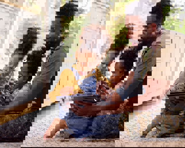 Army father with children tablet at home