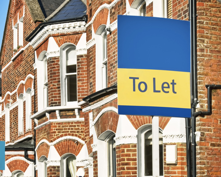 Row of terrace houses with to let sign