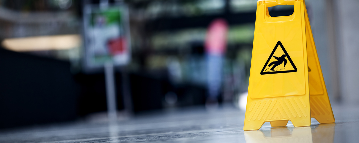 A caution sign in bright yellow reading  "Wet Floor," alerting individuals to potential slip hazards on a wet surface.