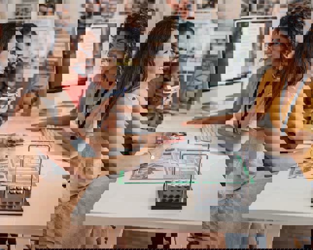 Couple consulting with a travel agent at a travel agency desk, discussing holiday or vacation plans