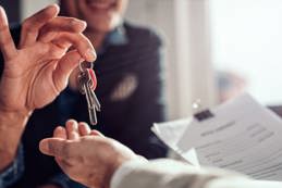 Real estate agent passing keys