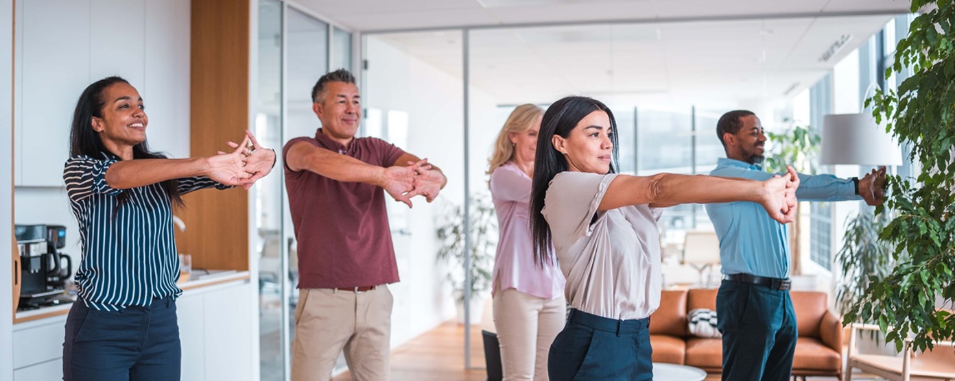 Colleagues doing yoga in an office