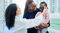 Woman and kids optometrist for eye test