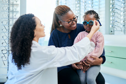 Woman and kids optometrist for eye test