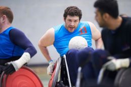 Man in a wheelchair playing a ball sport
