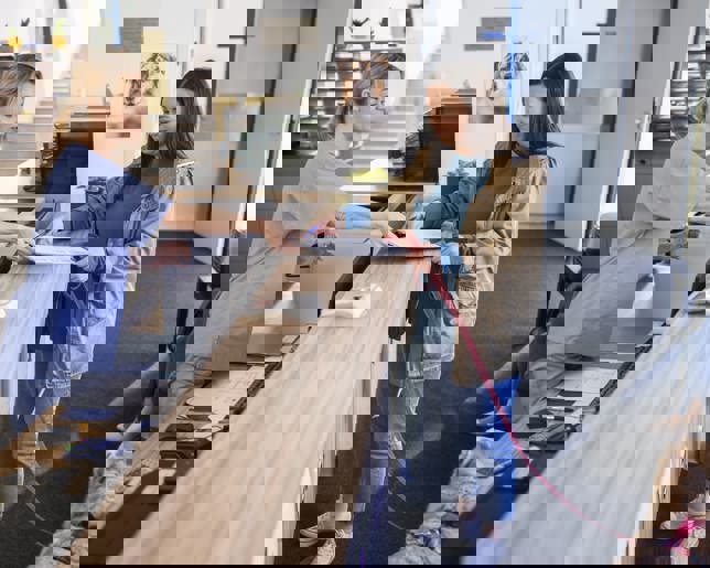 Woman with dog at vet reception