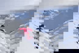 Military skier skiing down snowy slope