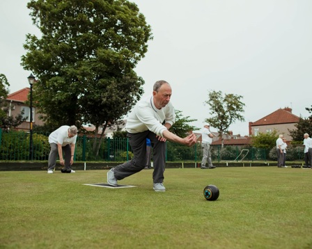 Older man playing bowls