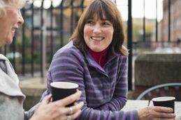 Two woman enjoying a hot beverage on a cold day.jpg