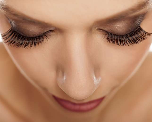 Close up of eyes with long artificial eyelashes