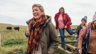 Mature women walking through a field on a winter day