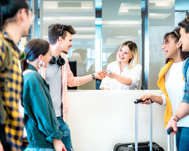 Young friends hotel check in