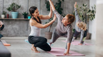 Yoga instructor guiding senior women
