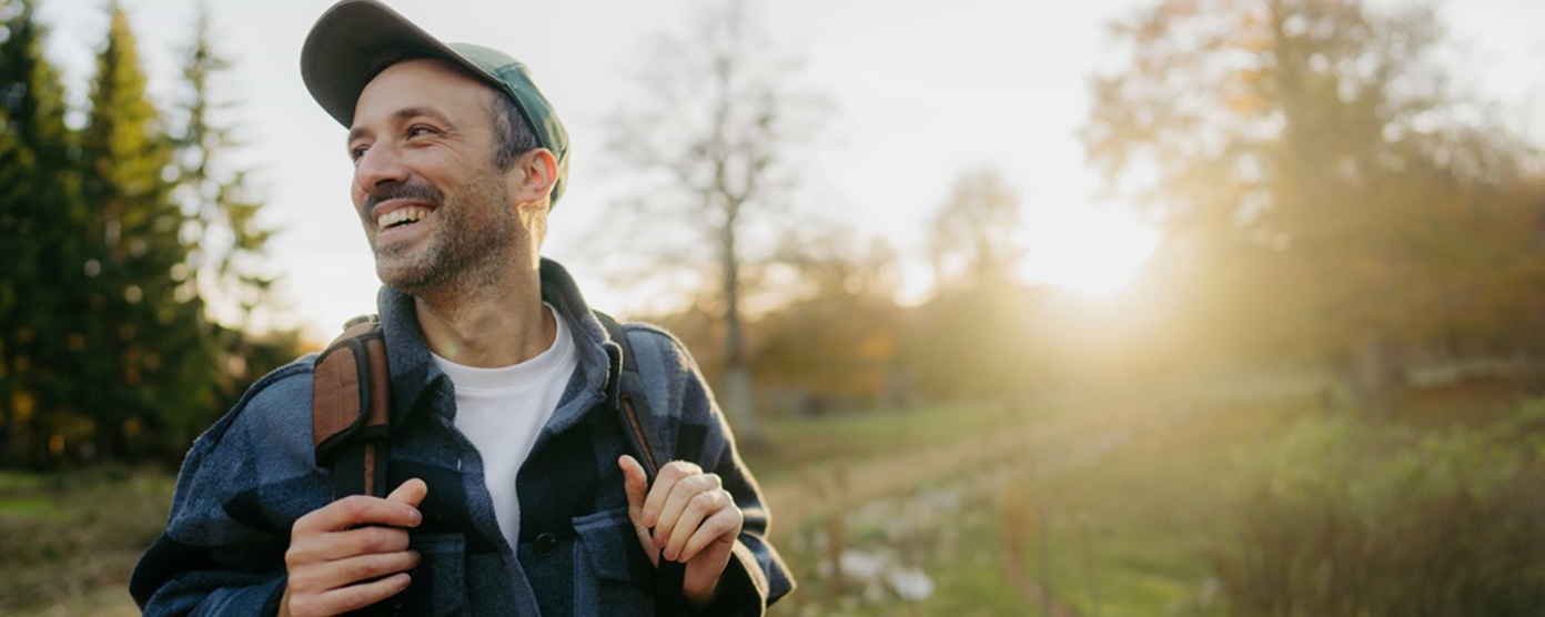 man walking outside and smiling