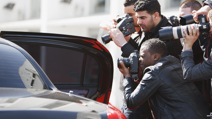 Paparazzi taking pictures of celebrity