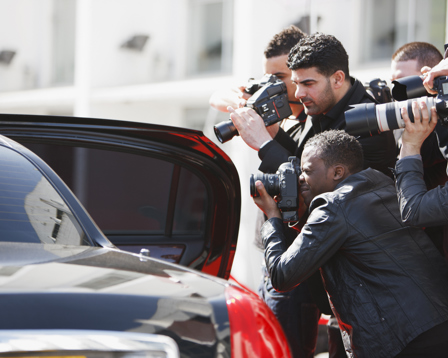 Paparazzi taking pictures of celebrity