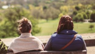 Two women looking into the distance on a bench.jpg