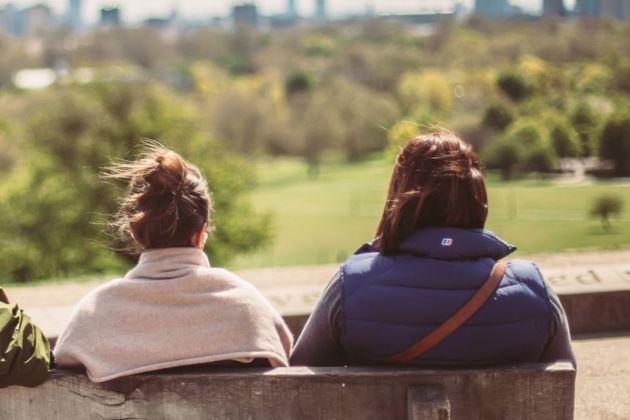 Two women looking into the distance on a bench.jpg