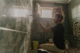 A young man renovating bathroom