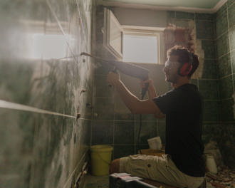A young man renovating bathroom