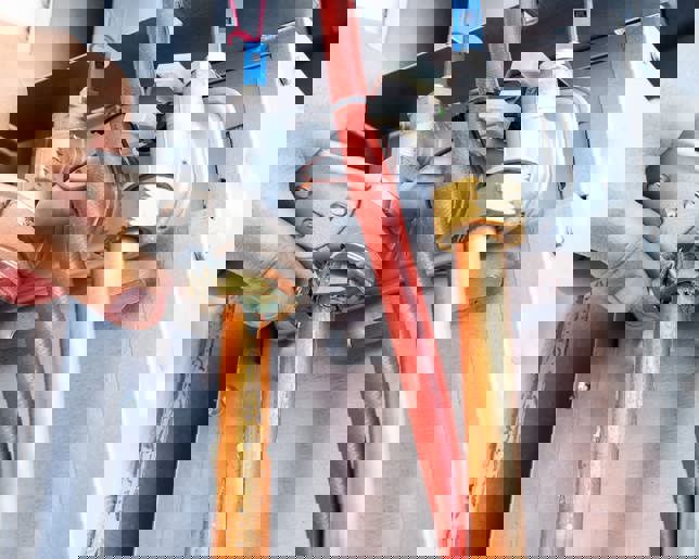 Plumber repairing a gas boiler of a heating home system.