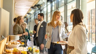 colleagues smiling at an office buffet