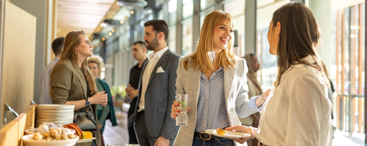 colleagues smiling at an office buffet