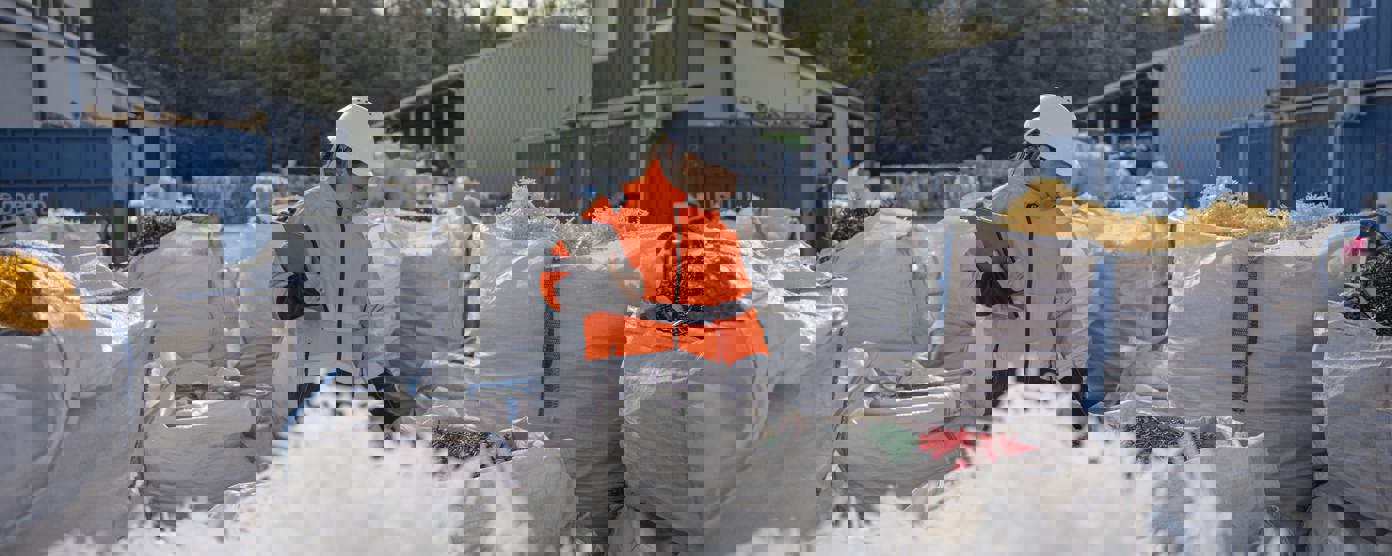 Recycling factory worker checking plastic resins