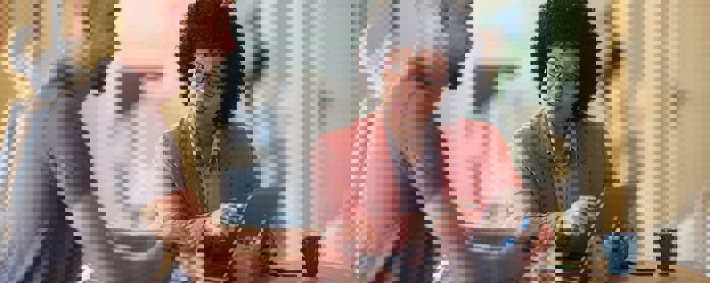 Female agent working on laptop with her customer in the office