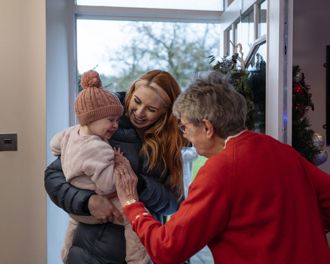 Family being greeted as they enter the front door
