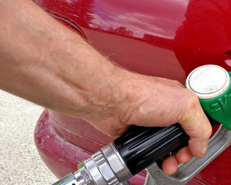 header-fuel-pump-nozzle-refueling-a-red-car