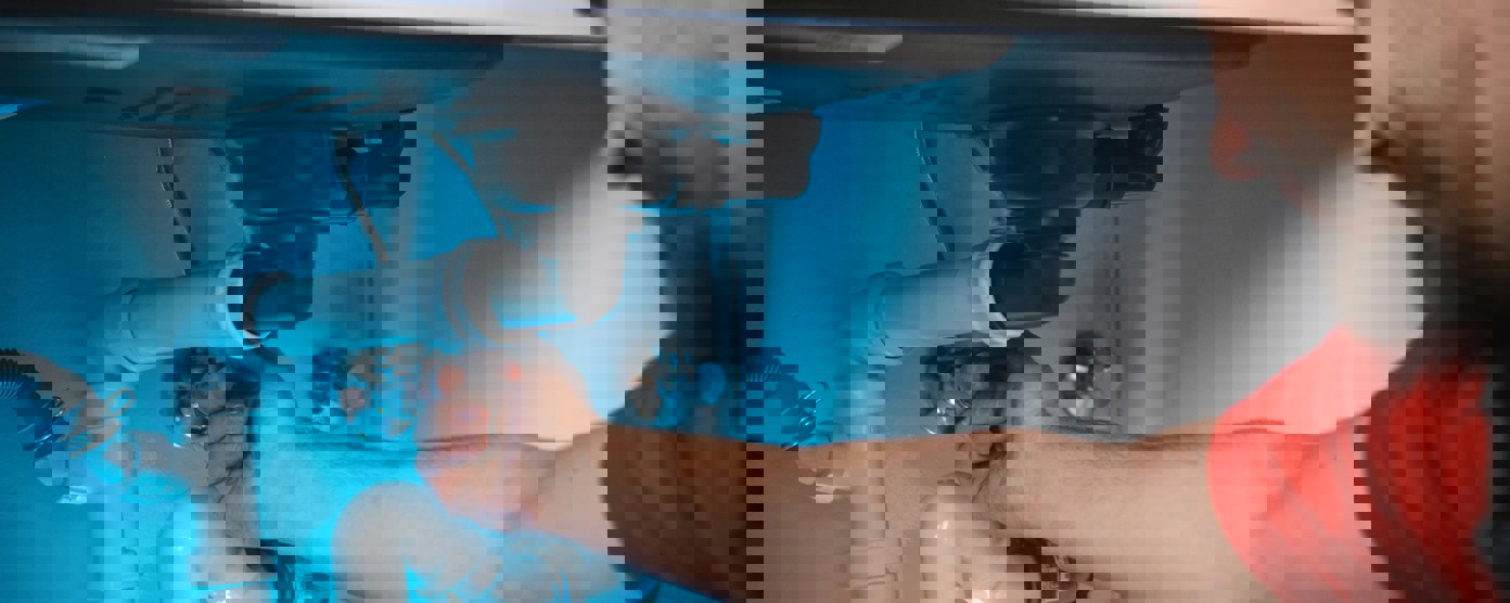 Plumber fixing sink pipes