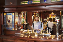 Pub landlord preparing paperwork