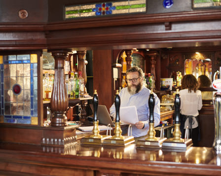 Pub landlord preparing paperwork