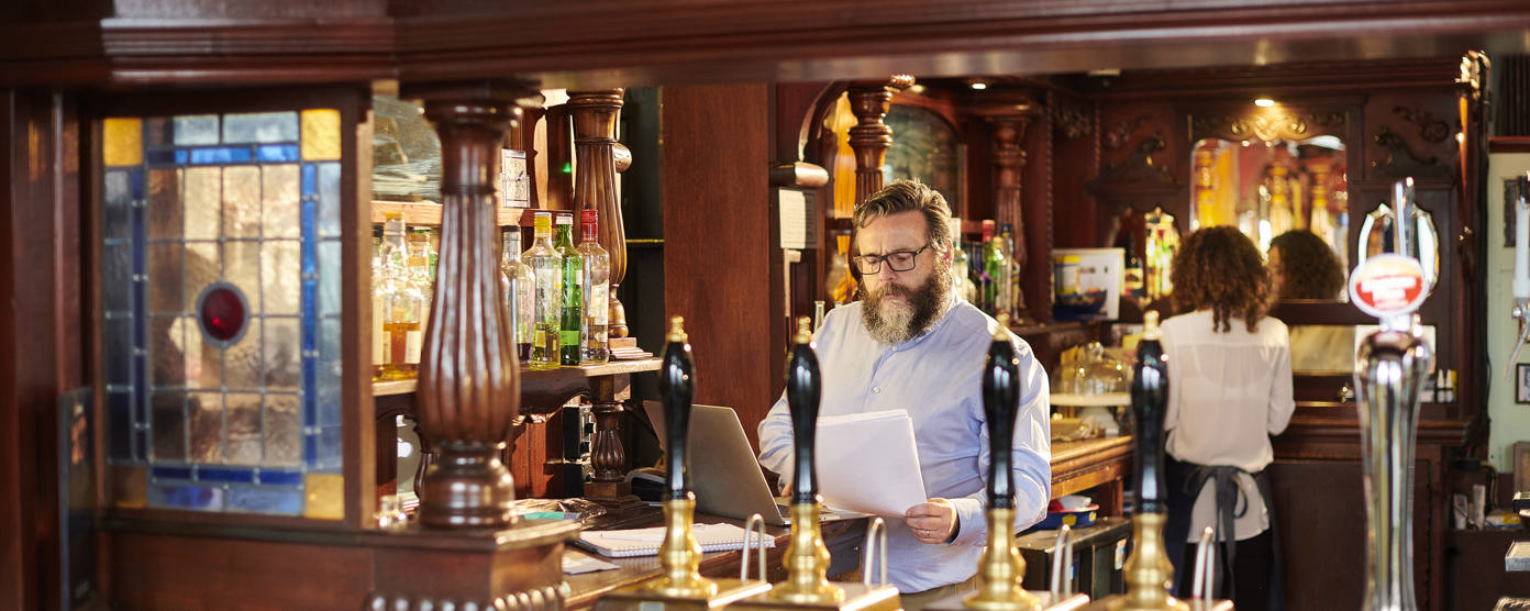 Pub landlord preparing paperwork
