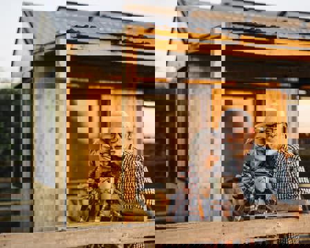 Senior couple cabin patio evening