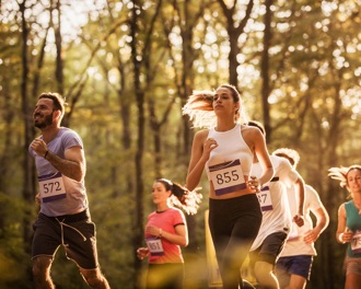 Runners in a sunlit forest