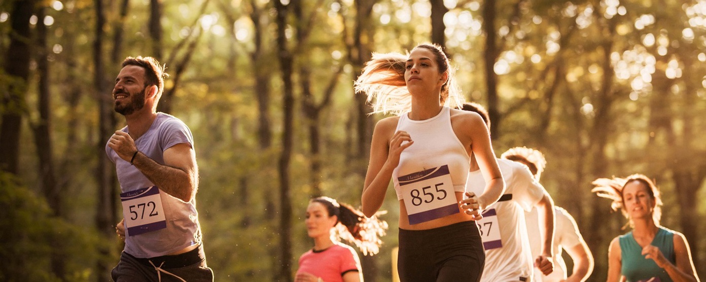 Runners in a sunlit forest