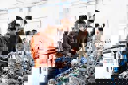 Robotic students using a digital tablet 