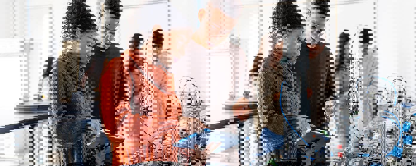 Robotic students using a digital tablet 