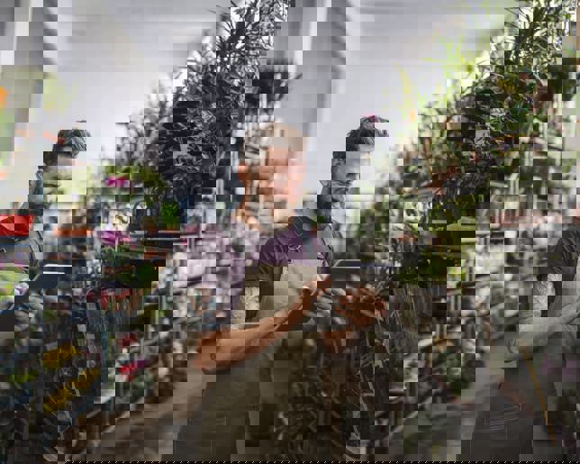 Male working in a garden centre using digital tablet