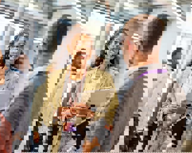 Colleagues conversing at a breakout session.jpg