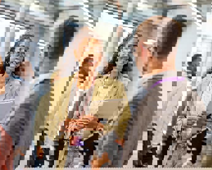 Colleagues conversing at a breakout session.jpg