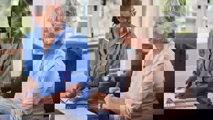 Senior woman talking to nurse